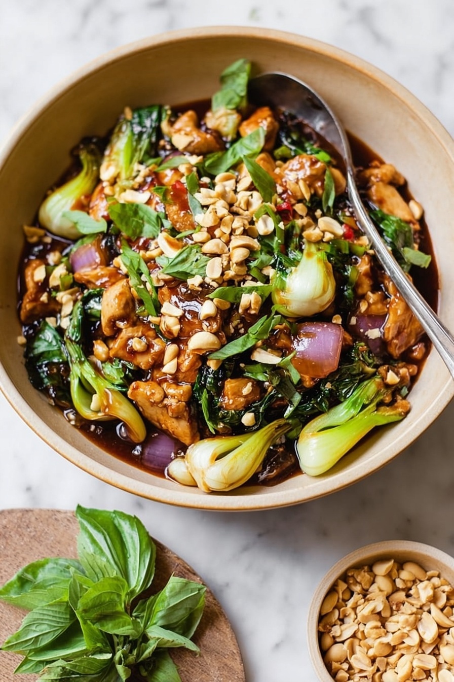 The image shows a light brown bowl filled with a colorful stir-fry dish. The dish has several visible layers: at the bottom, there is a glossy dark brown sauce; on top of this, pieces of light brown cooked chicken mixed with bright green bok choy and purple-red onion slices; scattered across the top are whole and chopped light tan peanuts, and fresh green basil leaves are spread evenly for a fresh look. A silver spoon sticks out from the bowl. Next to the bowl is a smaller light brown dish filled with chopped peanuts, placed on a white marbled surface. Some green basil leaves lay beside the bowl. Photo taken with an iphone --ar 2:3 --v 7