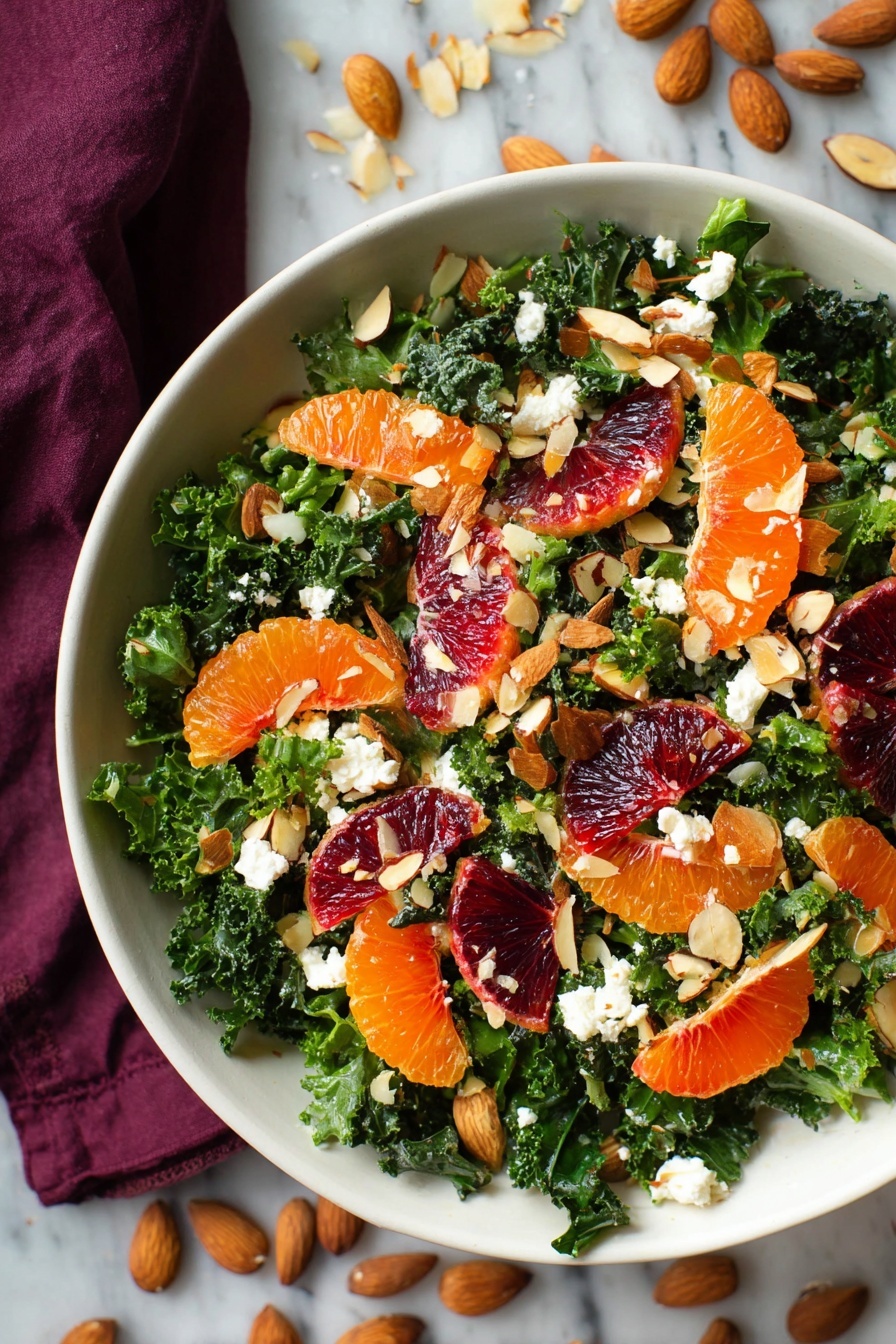 A white bowl filled with a fresh salad shows a base layer of dark green kale leaves with a slightly rough texture. On top, bright orange mandarin slices and rich red blood orange segments are spread evenly, adding vibrant color. Scattered throughout are small white dollops of cheese with a soft, crumbly texture. Thin toasted almond slices and whole almonds with a light brown color are sprinkled all over, adding crunch. The bowl sits on a white marbled surface with some almonds and kale leaves scattered nearby, and a dark purple cloth partially visible at the top photo taken with an iphone --ar 2:3 --v 7