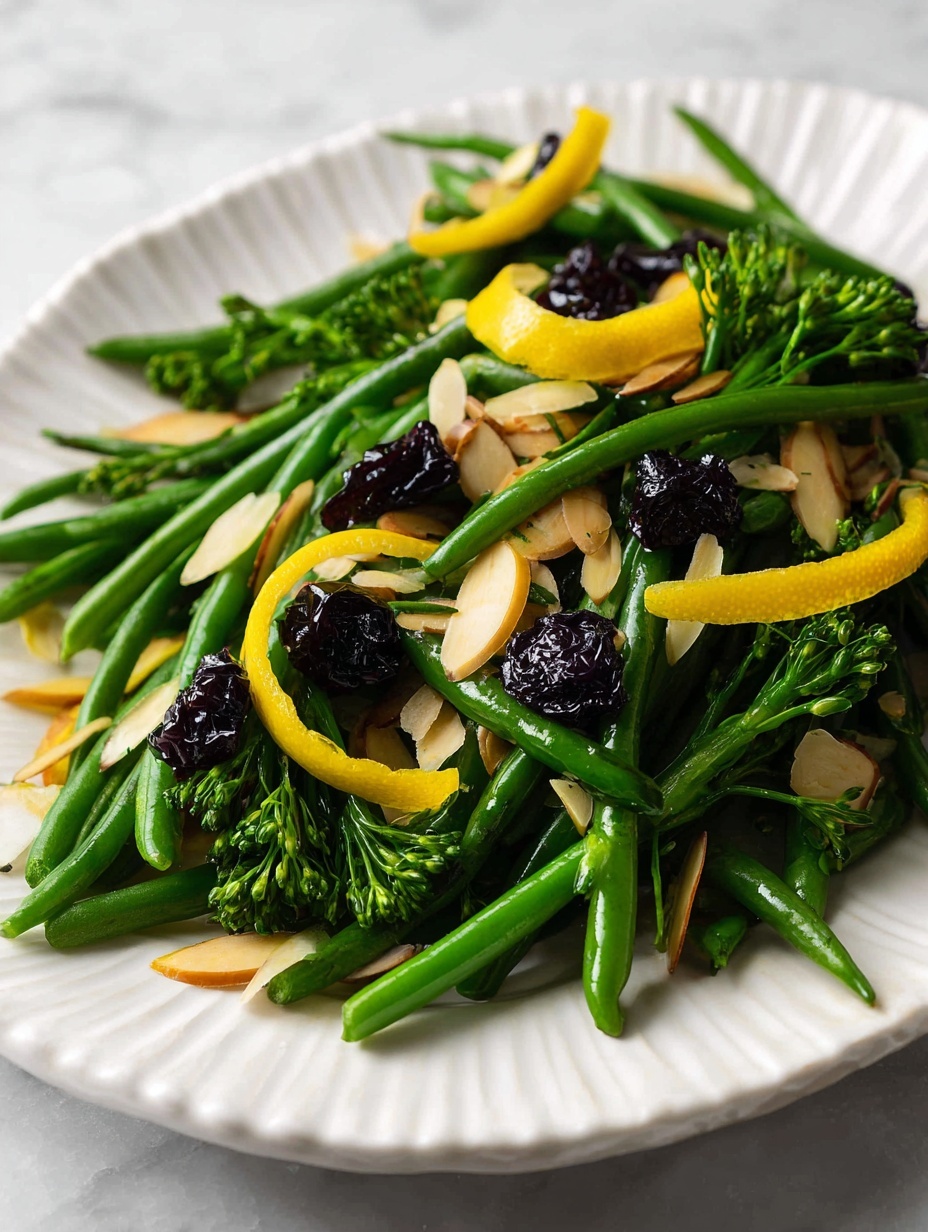 A white scalloped plate holds a vibrant salad of bright green green beans and broccolini, layered with thin, crunchy light brown almond slices scattered evenly on top. Dark, small dried black currants sprinkled throughout add contrast, while strips of shiny yellow lemon peel rest on the vegetables, adding a pop of color. A silver fork and spoon with intricate handles are placed on the right side of the plate. The background is a white marbled texture. Photo taken with an iphone --ar 2:3 --v 7