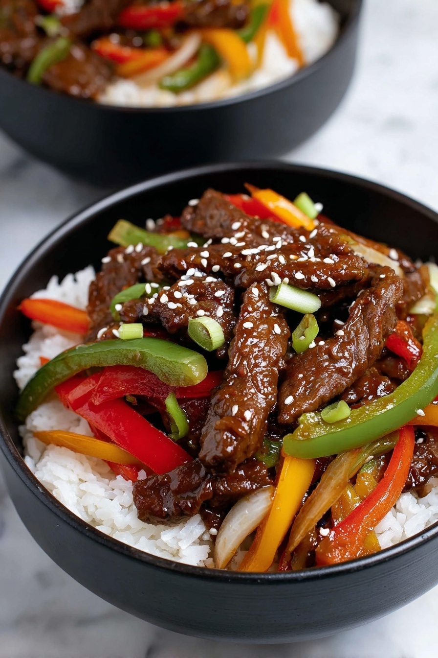 A black bowl filled with three layers: the bottom layer is white rice with a soft, grainy texture; the middle layer is colorful strips of bell peppers in green, red, yellow, and orange, mixed with small green onions and thinly sliced onions; the top layer consists of dark brown beef strips covered in a shiny sauce, sprinkled with white sesame seeds. The bowl sits on a white marbled surface, and another similar bowl is partially visible in the background. photo taken with an iphone --ar 2:3 --v 7
