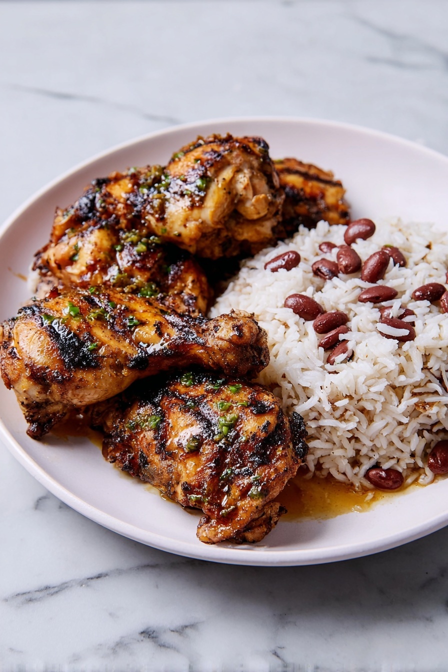 A white plate holds a serving of grilled chicken and rice with beans. The chicken has three pieces, each brown with visible char marks and a shiny, slightly oily surface, topped with small green herb bits. The chicken pieces are stacked slightly on the left side of the plate. On the right side, there is a mound of white rice mixed with small, dark red beans scattered throughout. The plate sits on a white marbled surface. photo taken with an iphone --ar 2:3 --v 7
