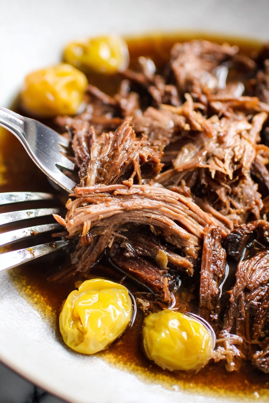 The dish shows a layer of creamy white mashed potatoes spread evenly on a white plate, topped with a generous pile of shredded dark brown meat. On top and among the meat are two yellow-green peppers adding a pop of color. The food is sprinkled with small chops of fresh green herbs, scattered lightly over the meat and potatoes. A knife with a wooden handle rests on the edge of the plate. The background is a white marbled surface with some green herbs and a bowl of yellow peppers nearby. photo taken with an iphone --ar 2:3 --v 7